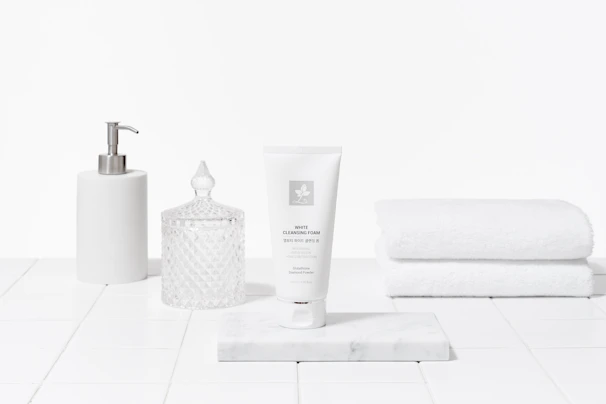 Elegant arrangement of Korean sunscreen tubes and creams on a clean white marble countertop.