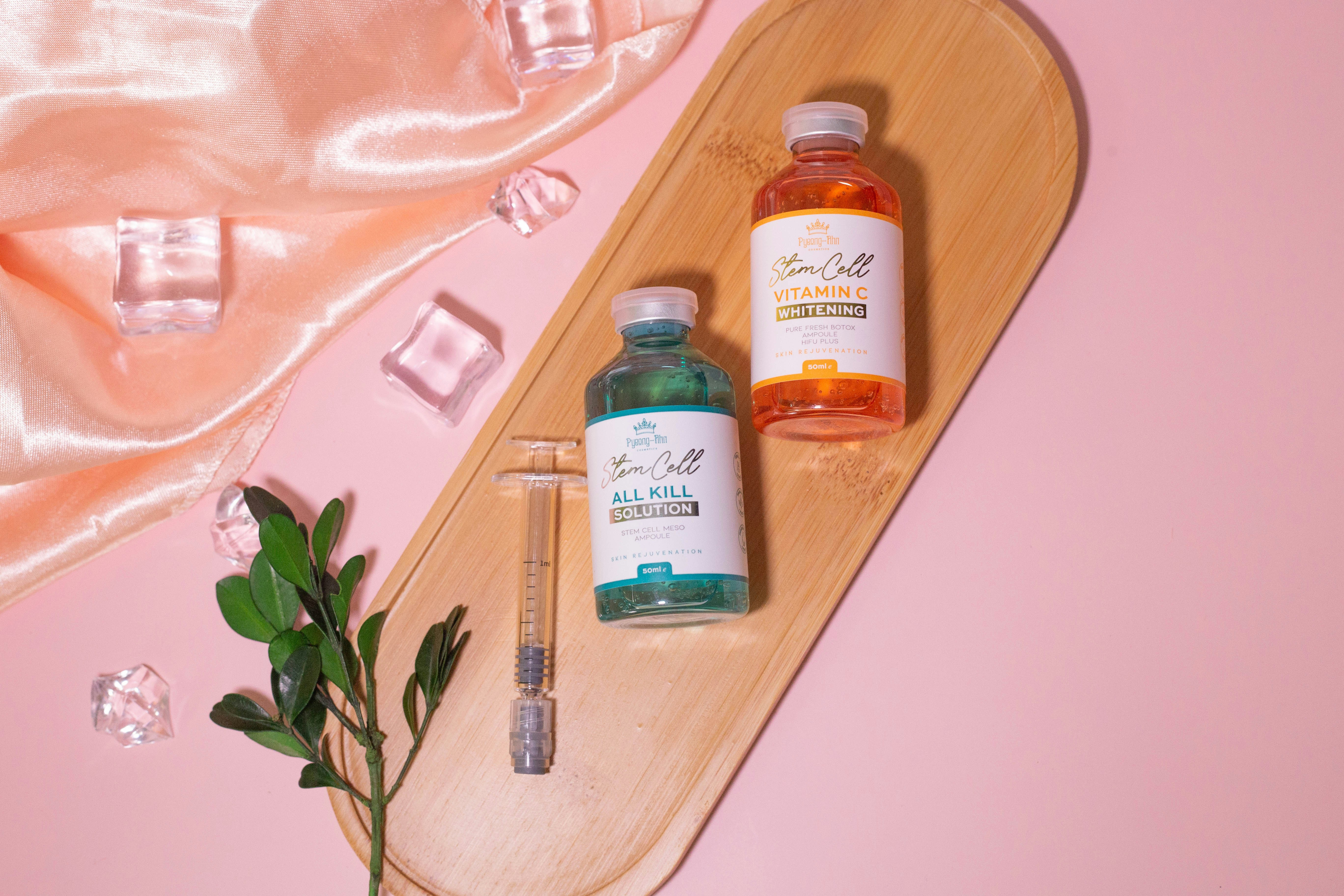 a bottle of vitamins and a bottle of medicine on a wooden tray