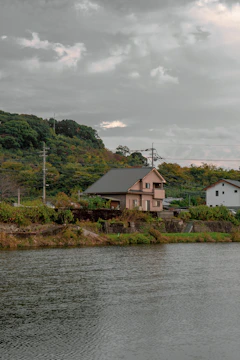 A sleek coastal house with glass facades and a green living roof overlooking the Scottish sea.