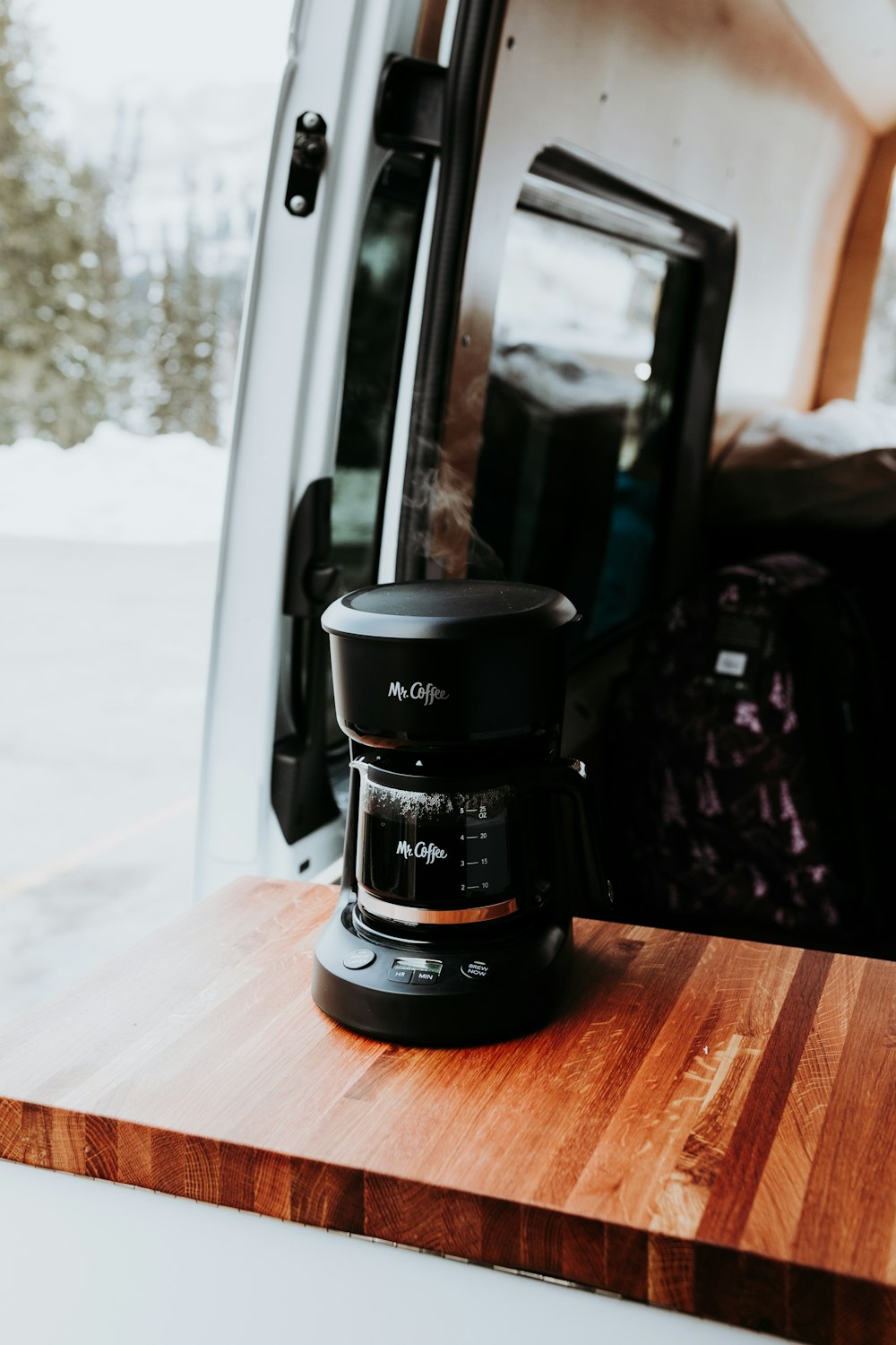 a coffee maker sitting on top of a wooden table