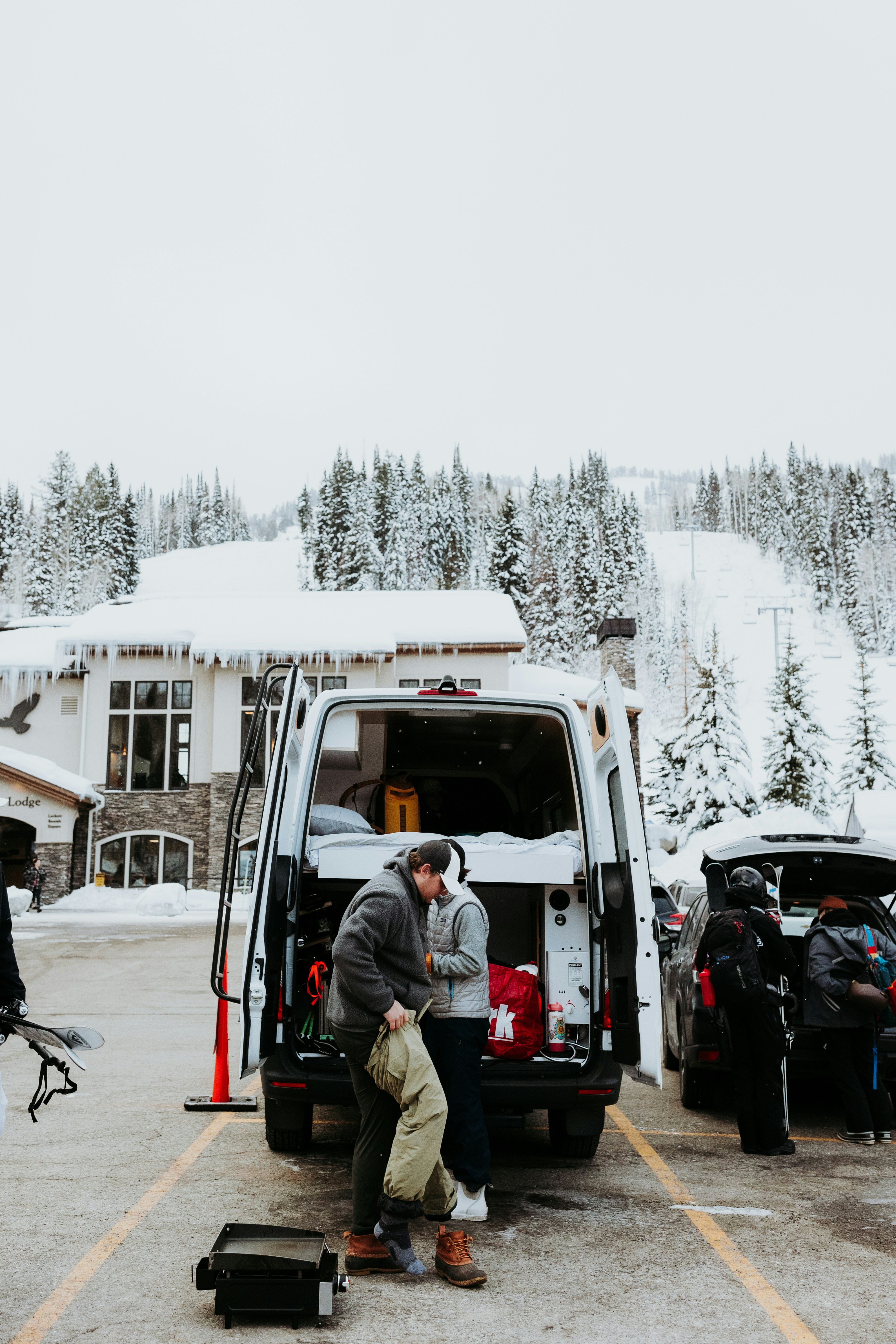 a couple of people that are standing in front of a van