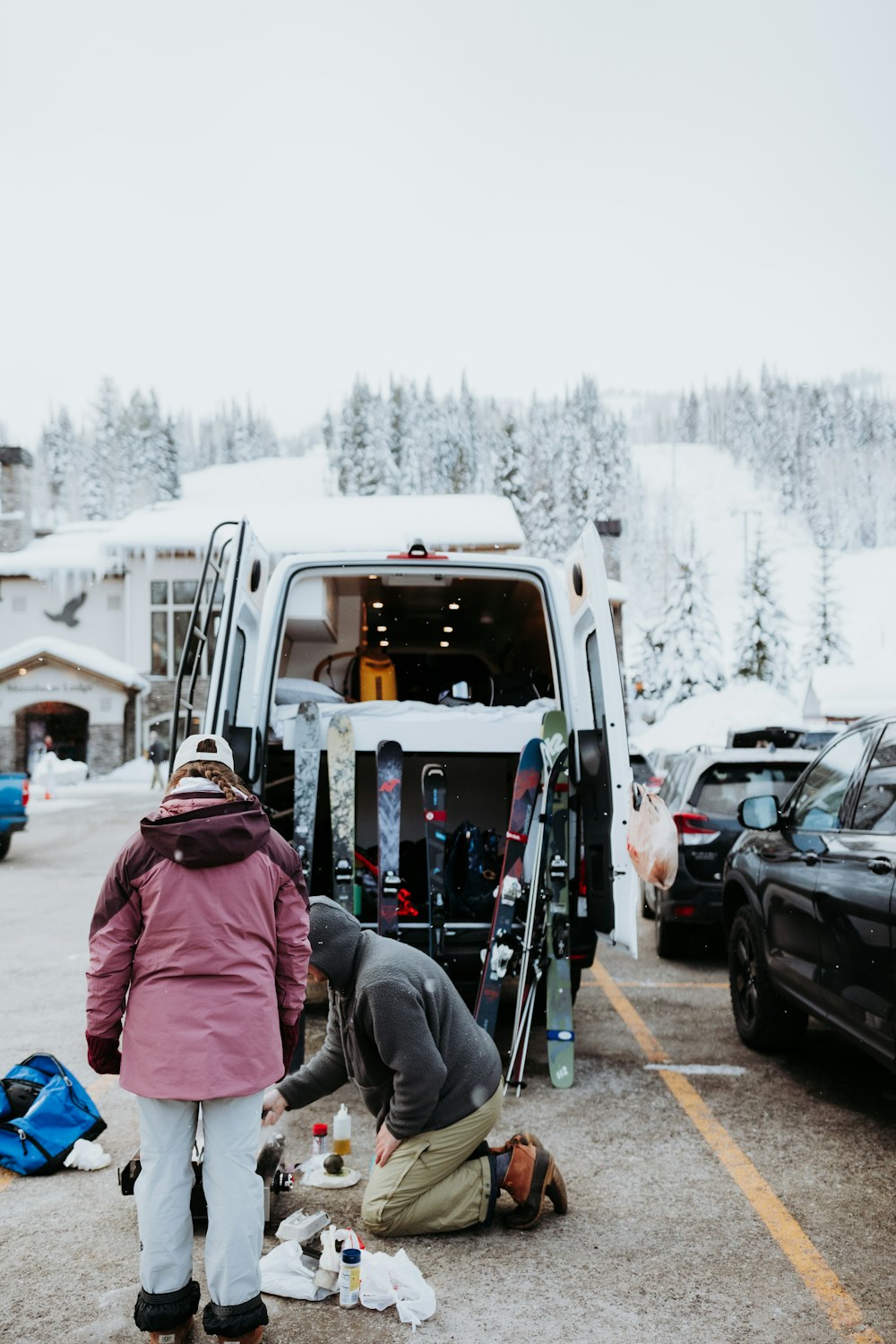 a couple of people standing in front of a van