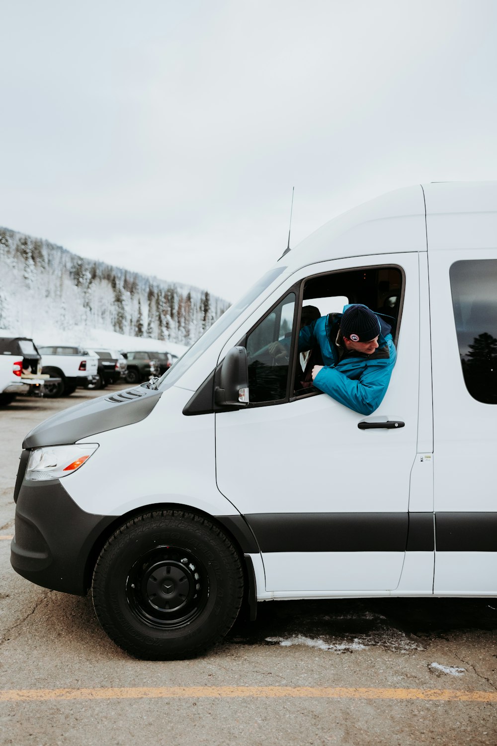 a person sitting in a van in a parking lot