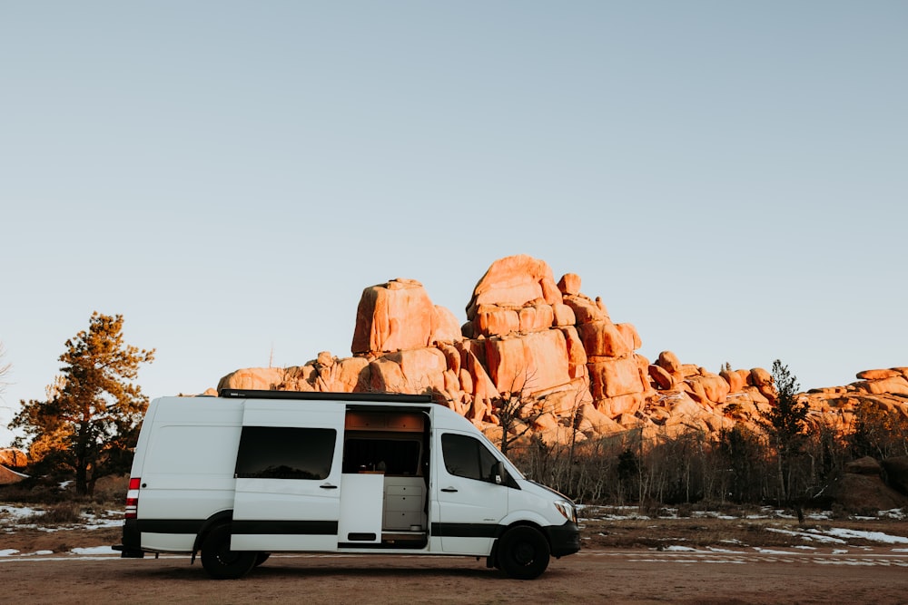 a white van parked in front of a mountain