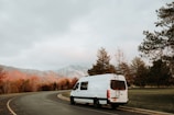 a white van driving down a curvy road