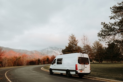 a white van driving down a curvy road