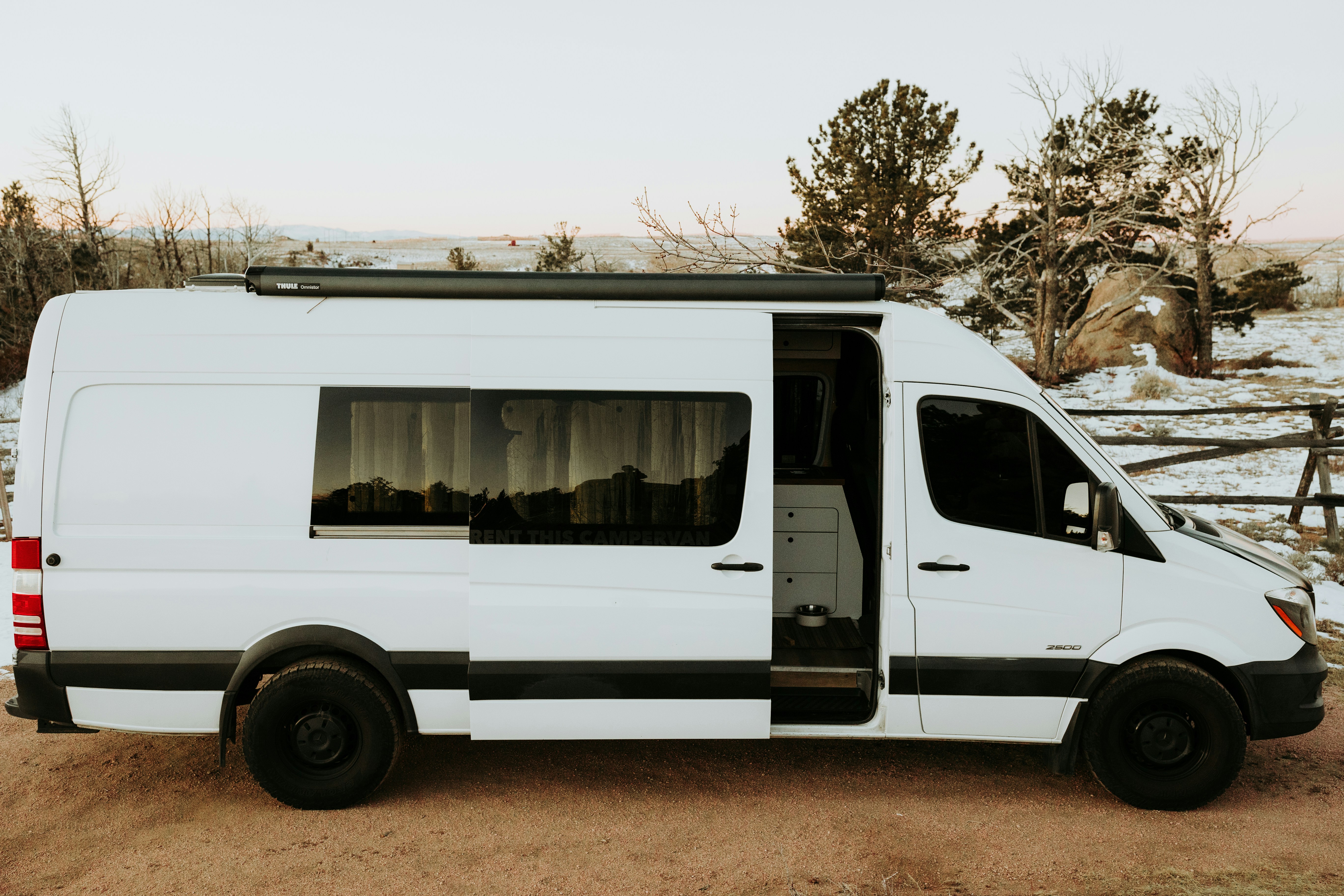 luxury overland vehicle sprinter van with high end outdoor gear deployed