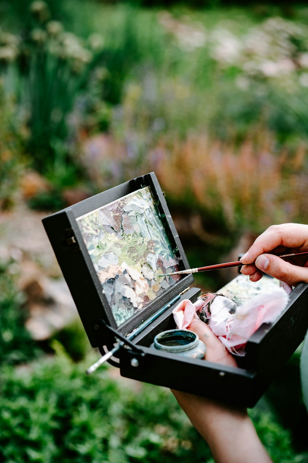 a person is painting a picture in a box