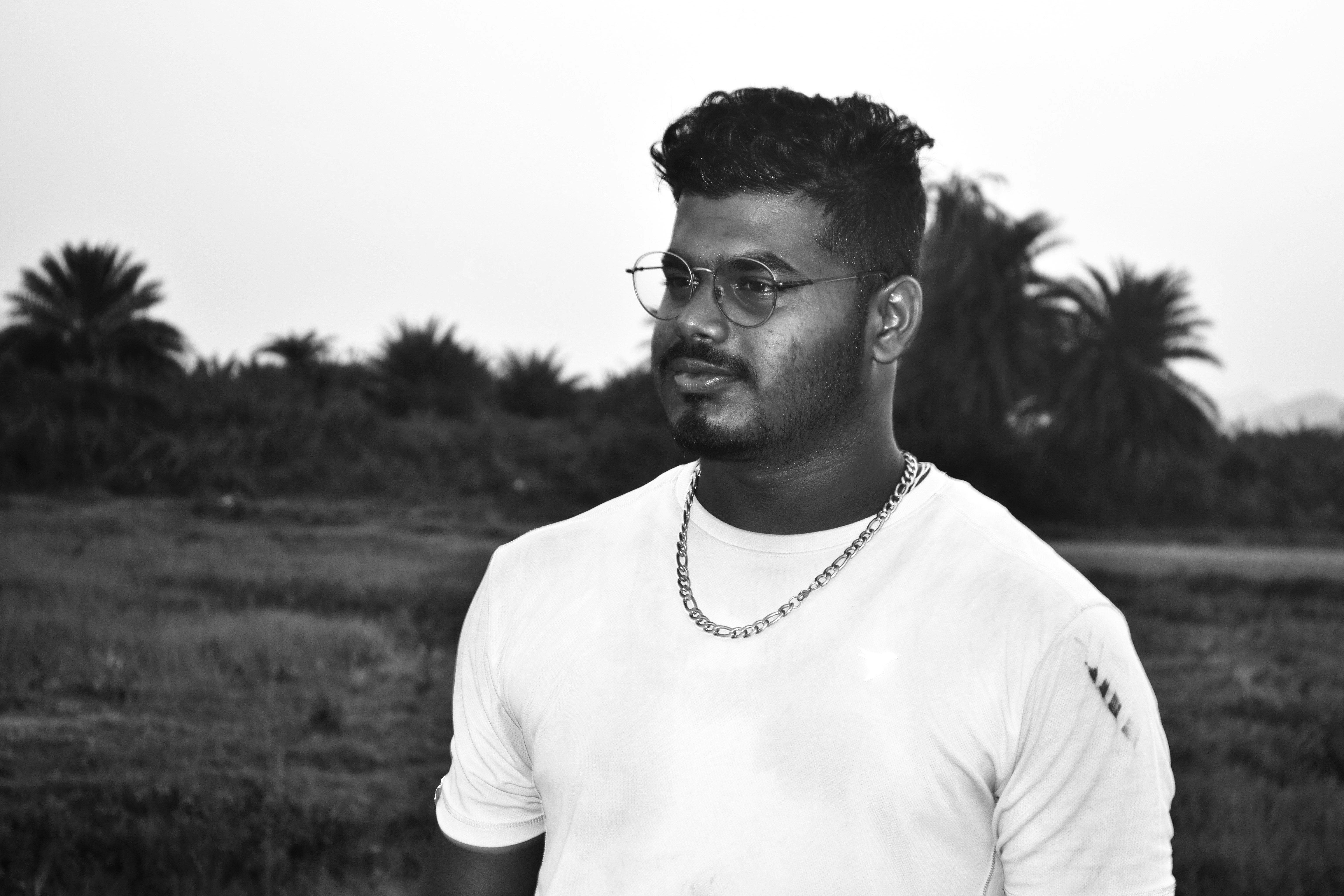 a black and white photo of a man wearing glasses