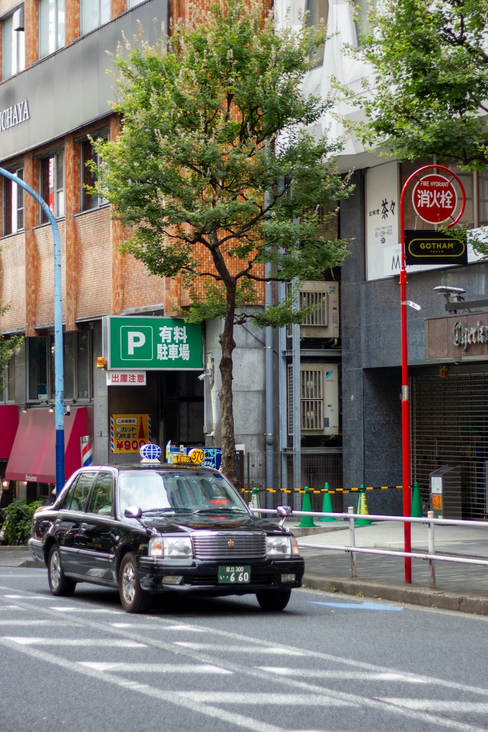 a police car driving down a street next to a tall building