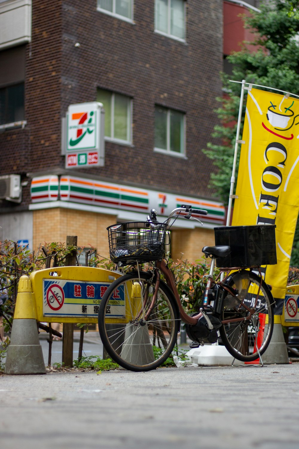 a bicycle parked next to a yellow sign