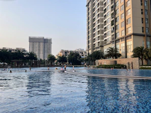 Family enjoying the swimming pool and sports courts in the urbanization.