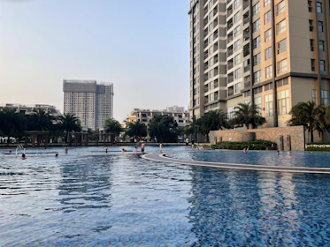 Family enjoying the swimming pool and sports courts in the urbanization.