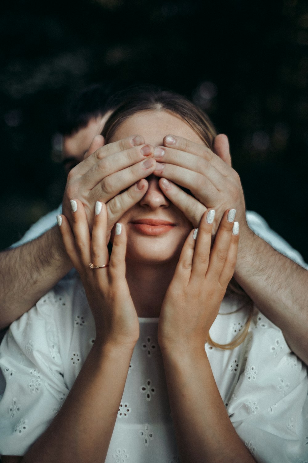 a woman covering her eyes with her hands