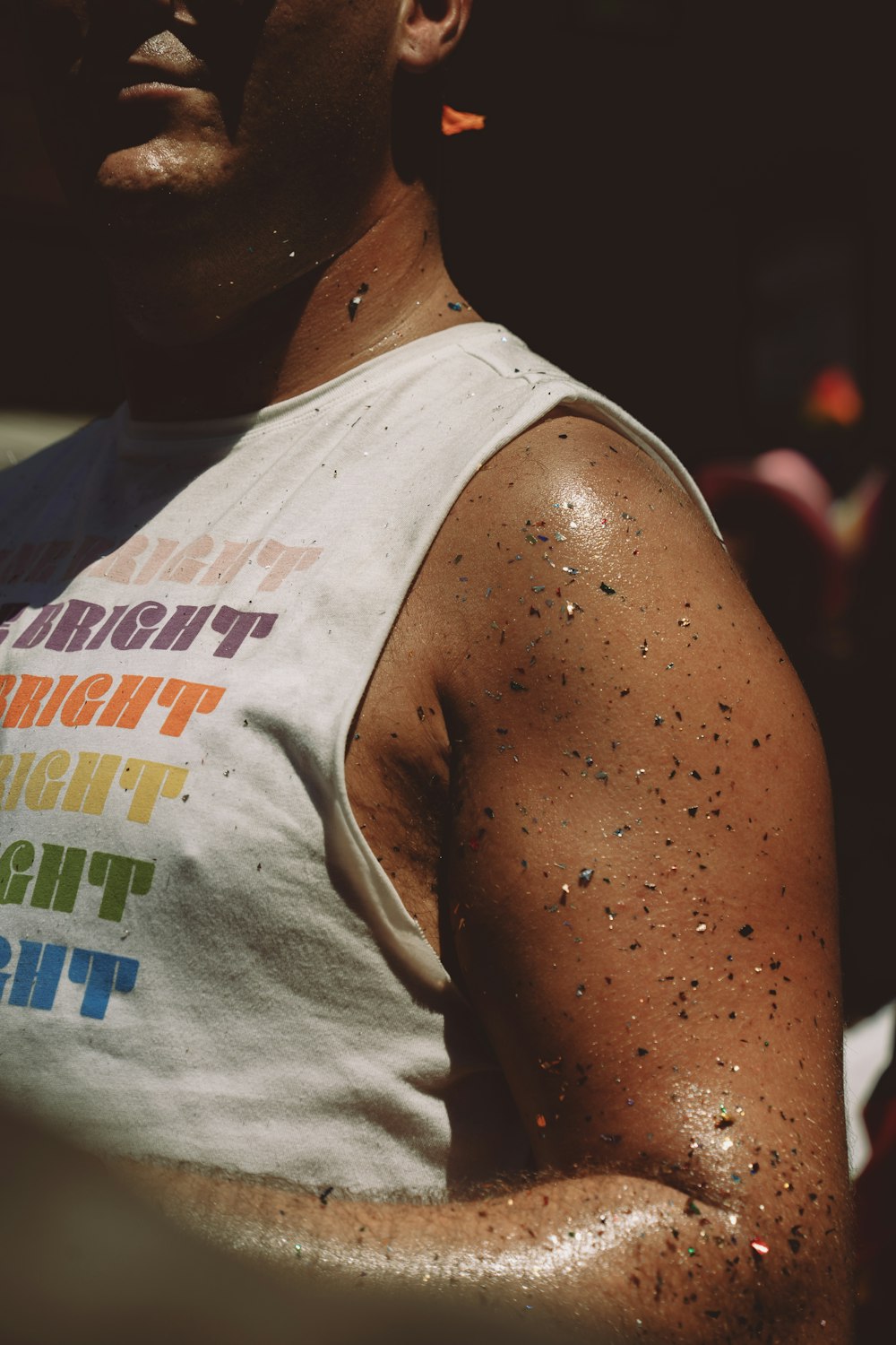 a man in a tank top covered in dirt