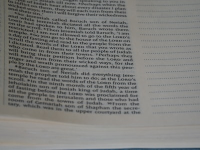 The image features a close-up view of a page from a book. The text is printed in two columns with a noticeable indentation for quotes or significant sections. The right side of the page has a dotted margin, possibly indicating annotation space. The text deals with biblical content, referencing the Lord, Baruch son of Neriah, and Jeremiah.