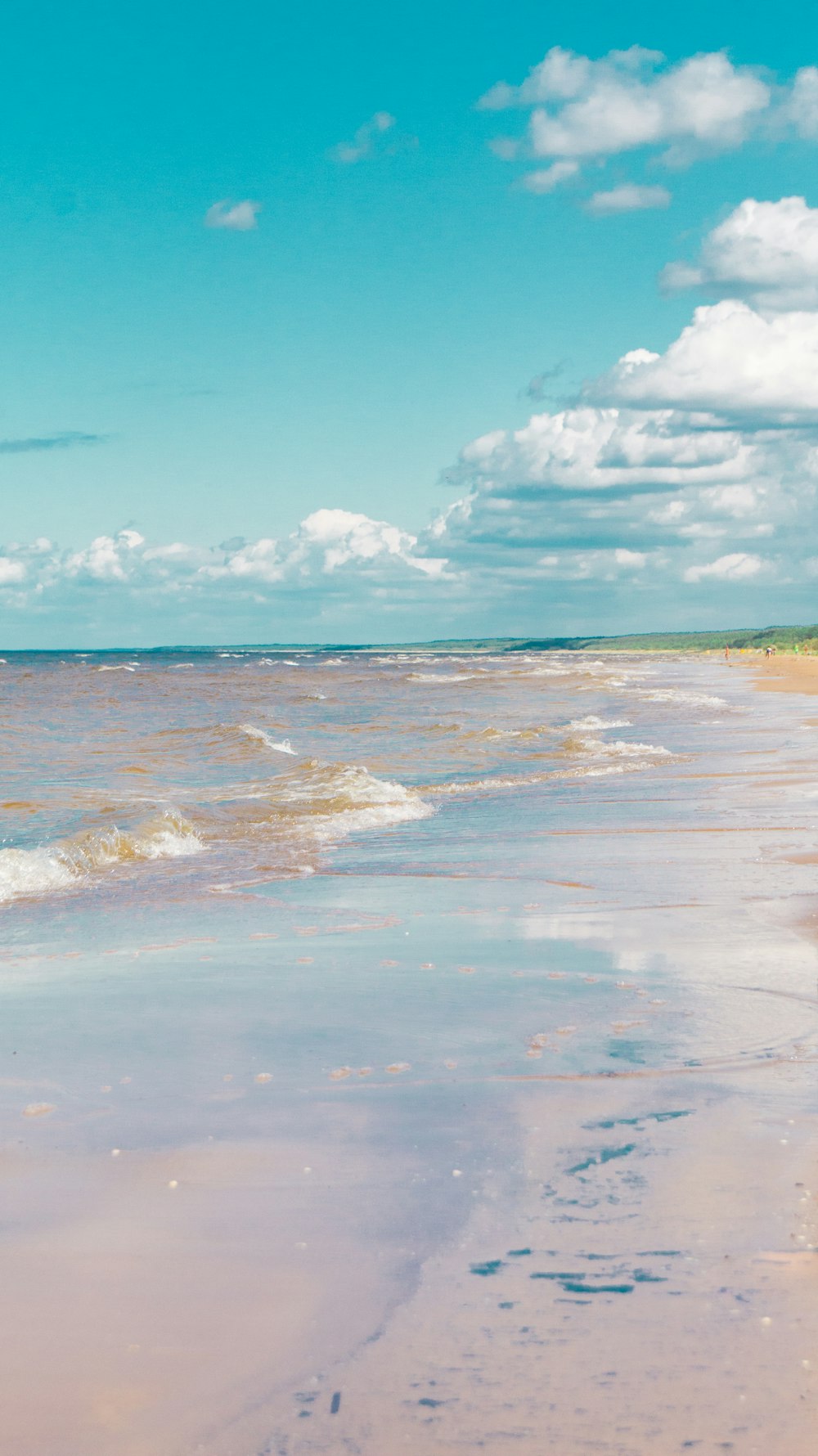 a person riding a surfboard on the beach