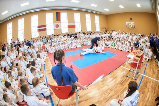 a large group of people sitting in chairs in a gym