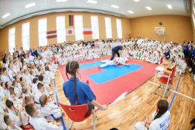 a large group of people sitting in chairs in a gym