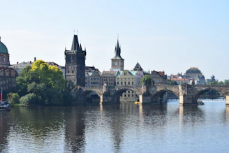 Historic stone bridge crossing a gentle river with lush greenery