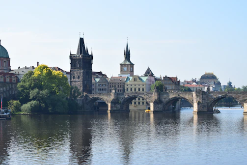 Historic stone bridge crossing a gentle river with lush greenery