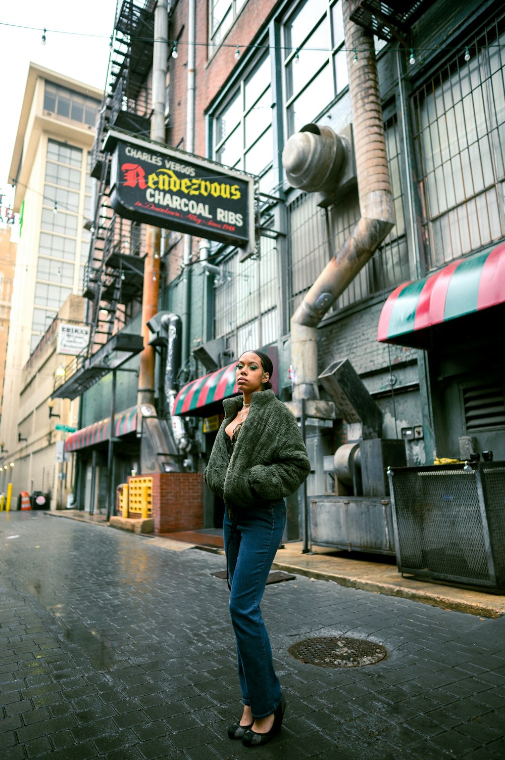 a woman standing on a city street talking on a cell phone