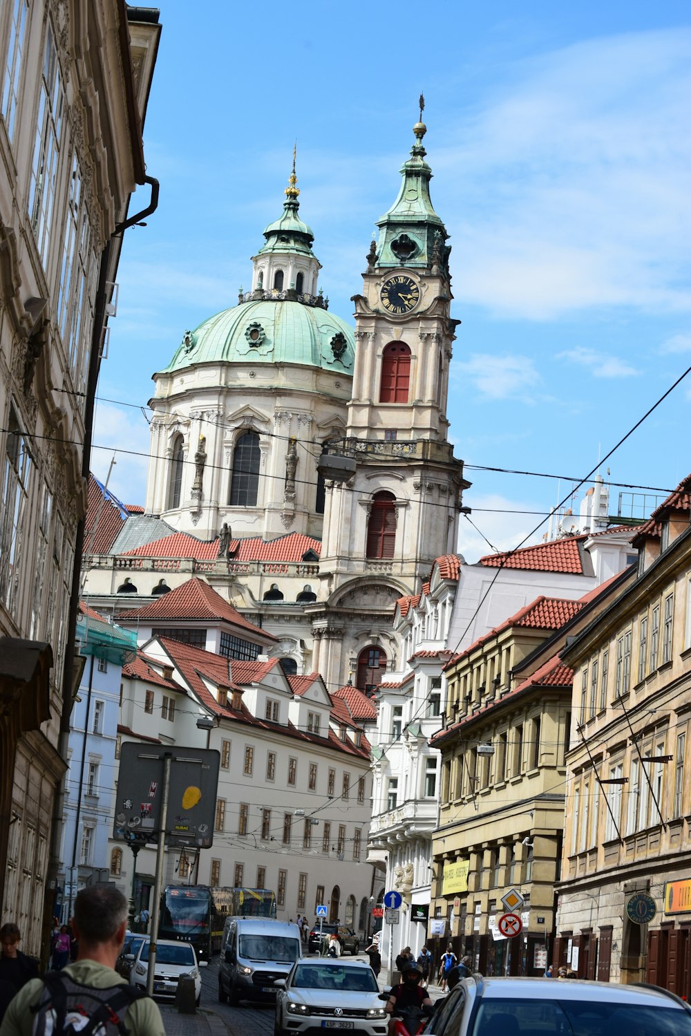 a city street lined with tall buildings and tall towers