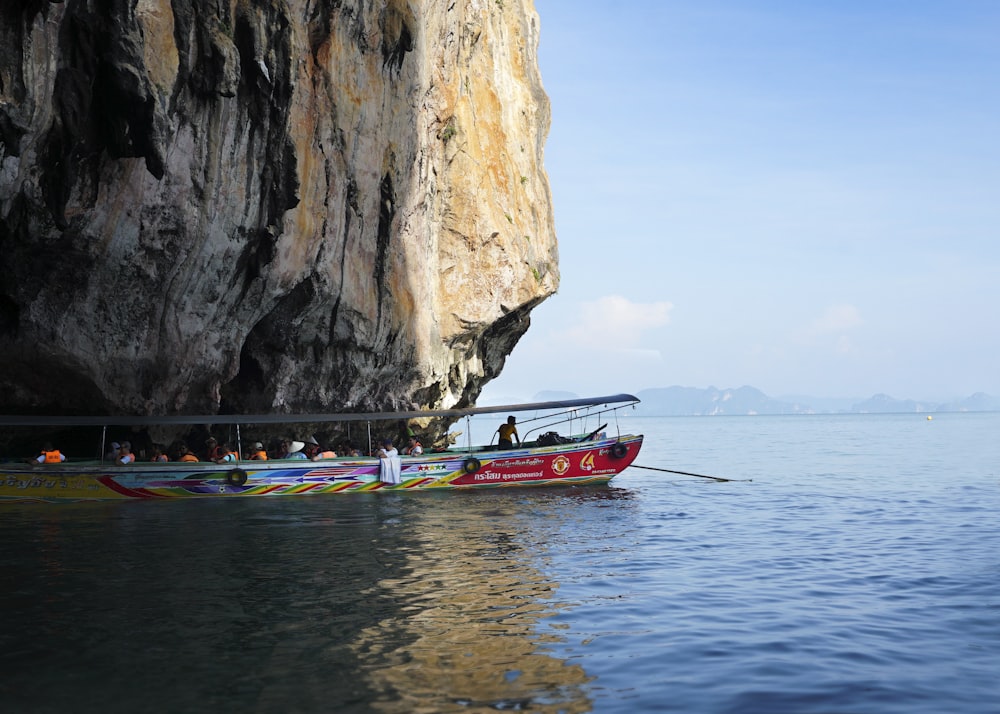 a long boat with people on it in the water