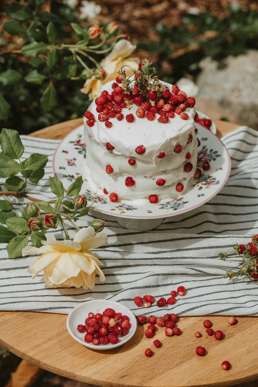 a white cake with red berries on top of it