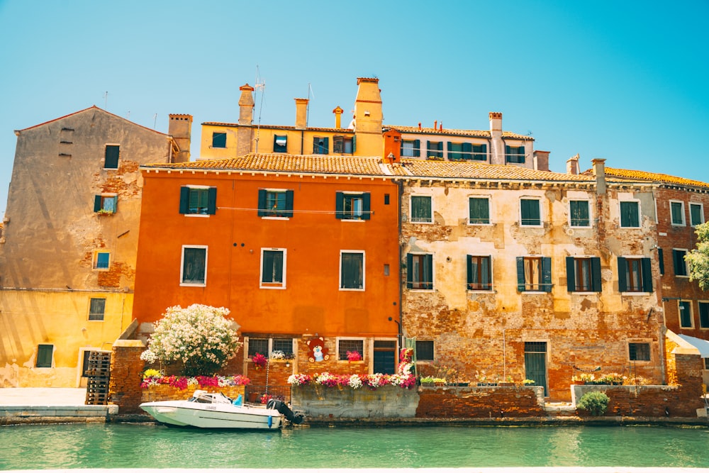 a boat in a body of water next to a building