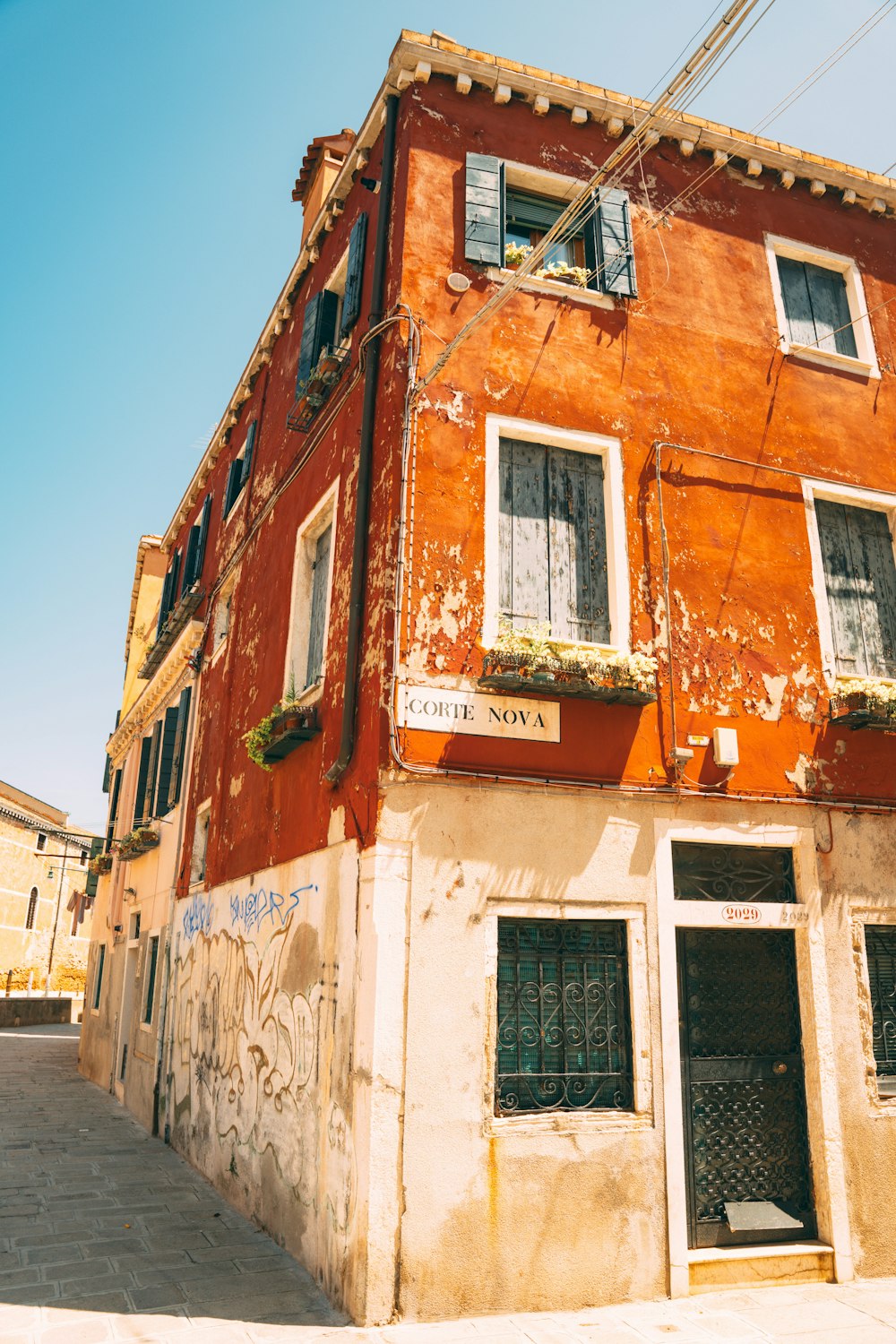 a red building with windows on the side of it