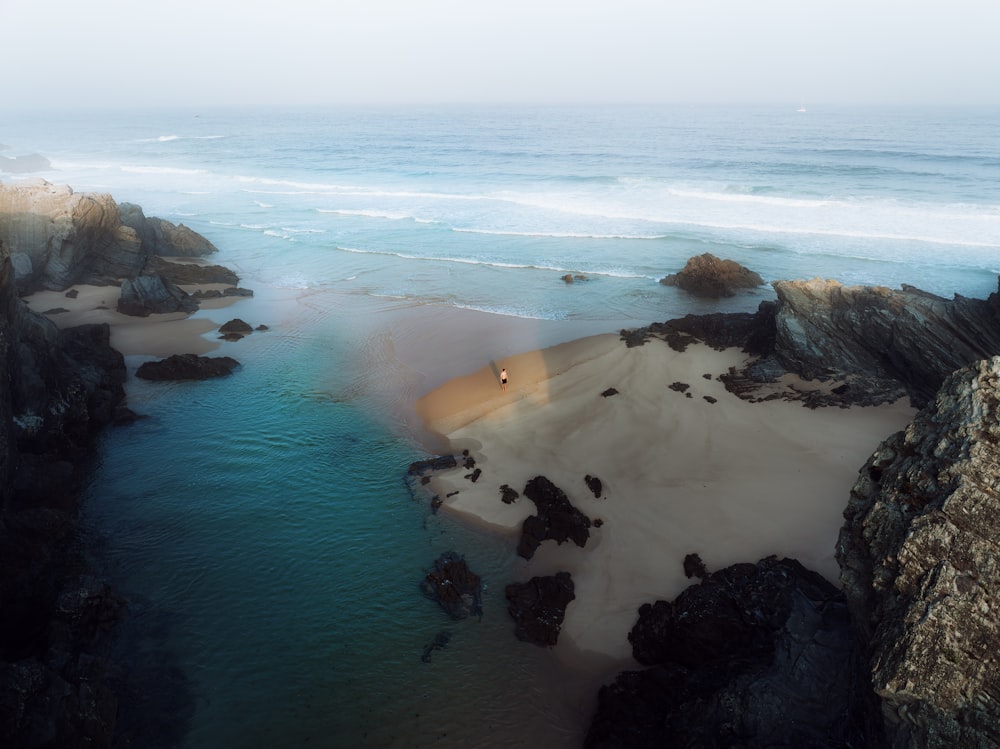 an aerial view of a beach with a body of water