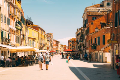 A vibrant city street scene featuring colorful architecture and locals enjoying an outdoor café.
