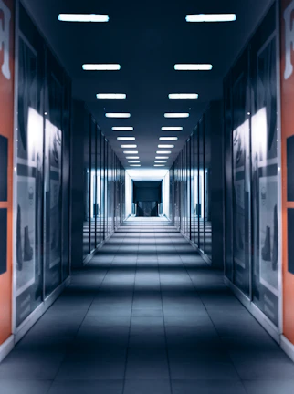 a long hallway with a bunch of lights on the ceiling
