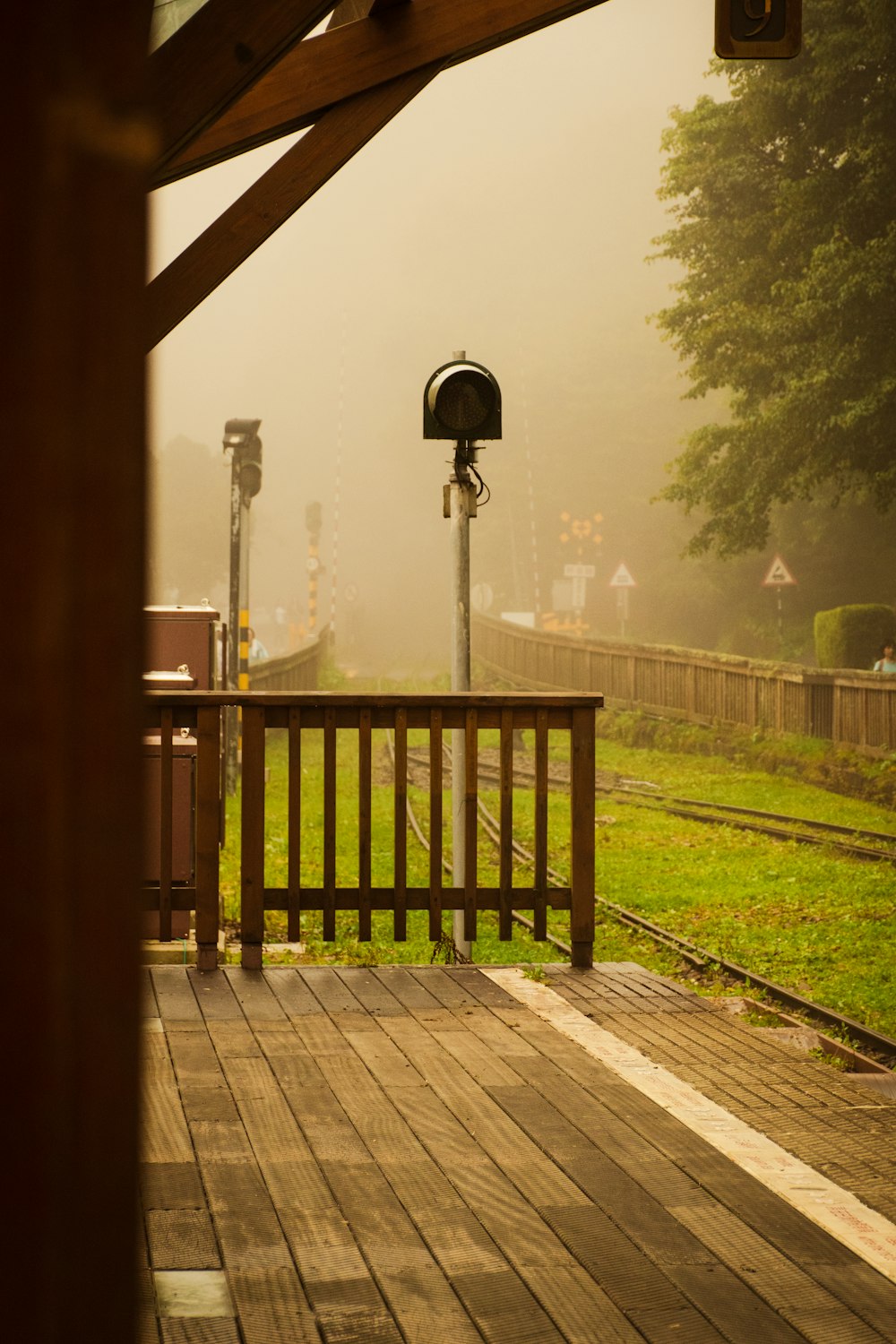 a wooden deck with a mailbox on top of it