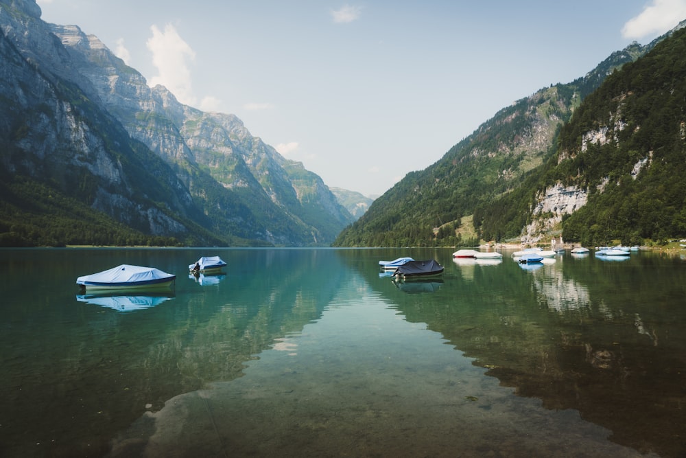 a group of boats floating on top of a lake