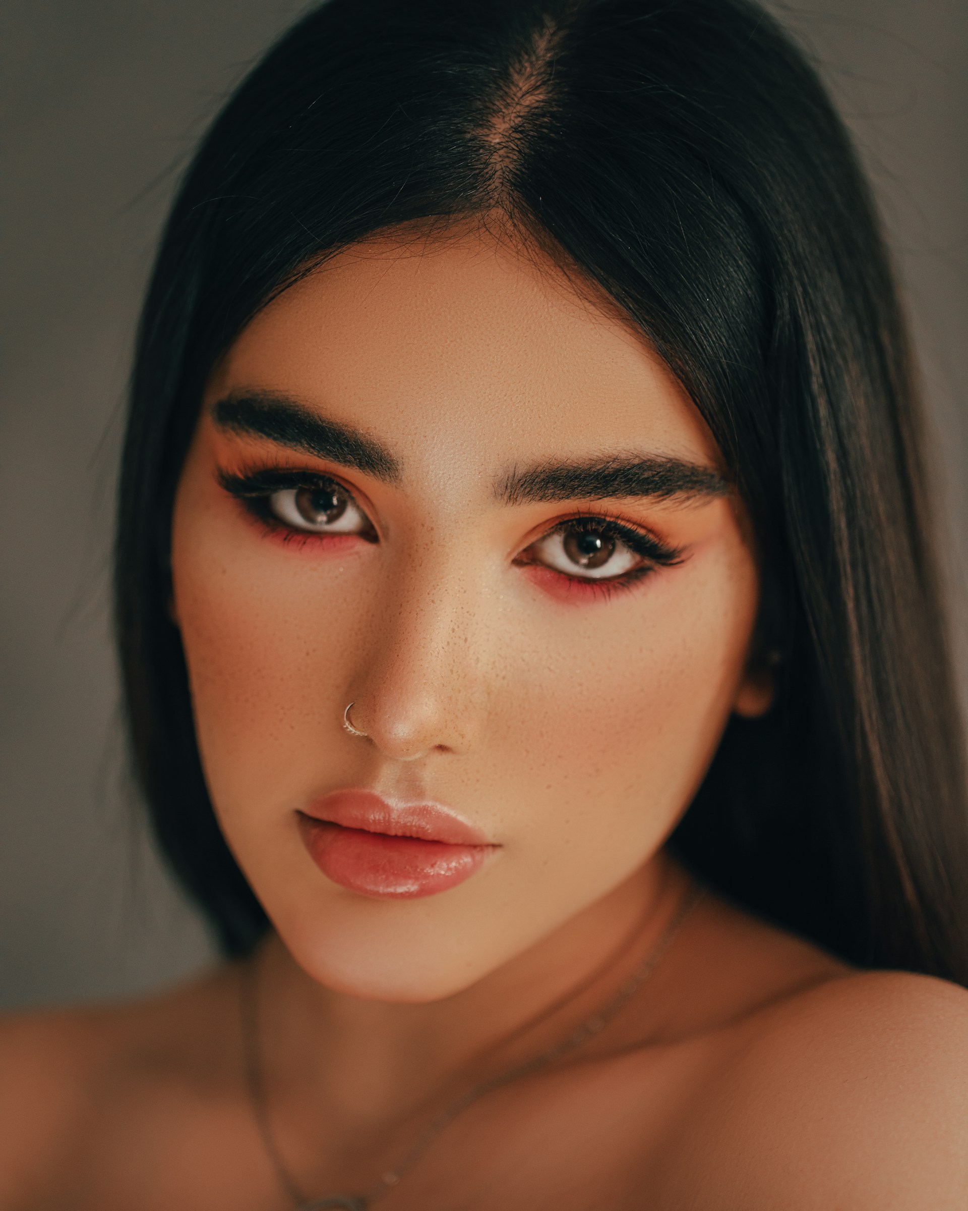 A striking before-and-after portrait showcasing natural skin retouching that enhances without losing character.