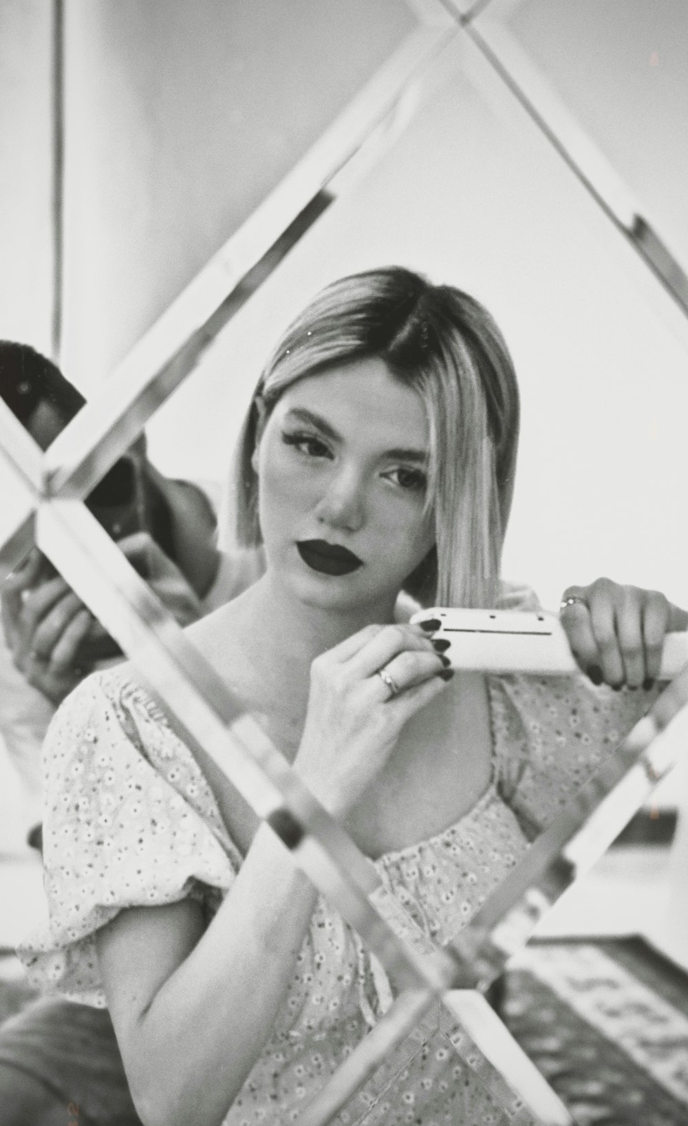 a black and white photo of a woman brushing her teeth