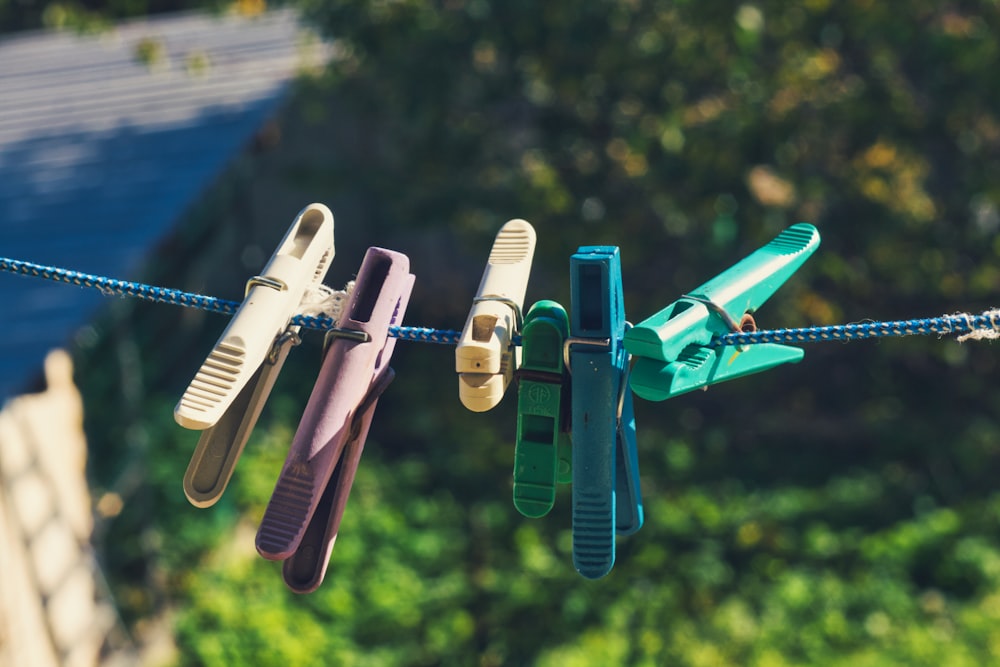 a line of clothes pins hanging from a clothes line