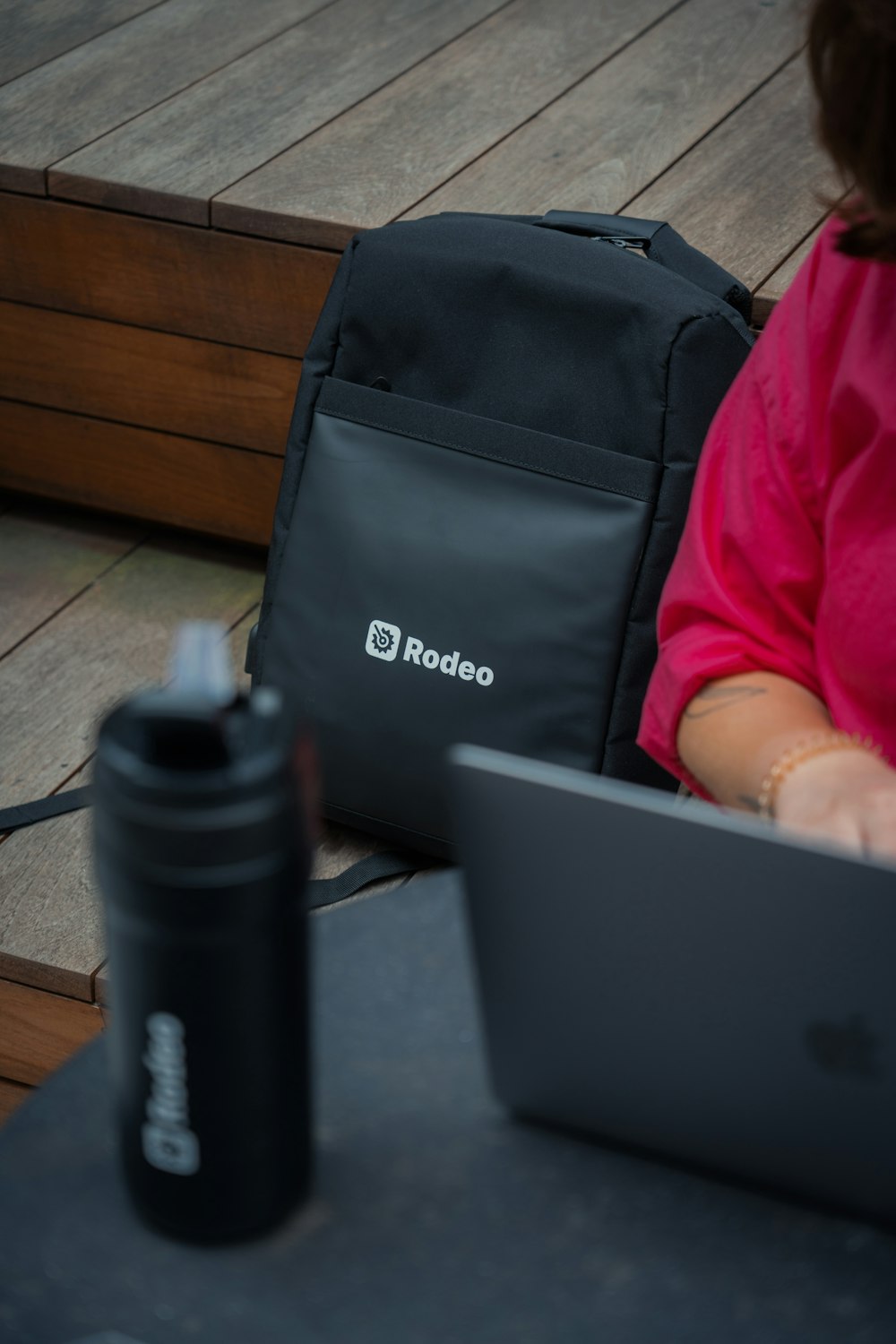 a woman sitting at a table using a laptop computer