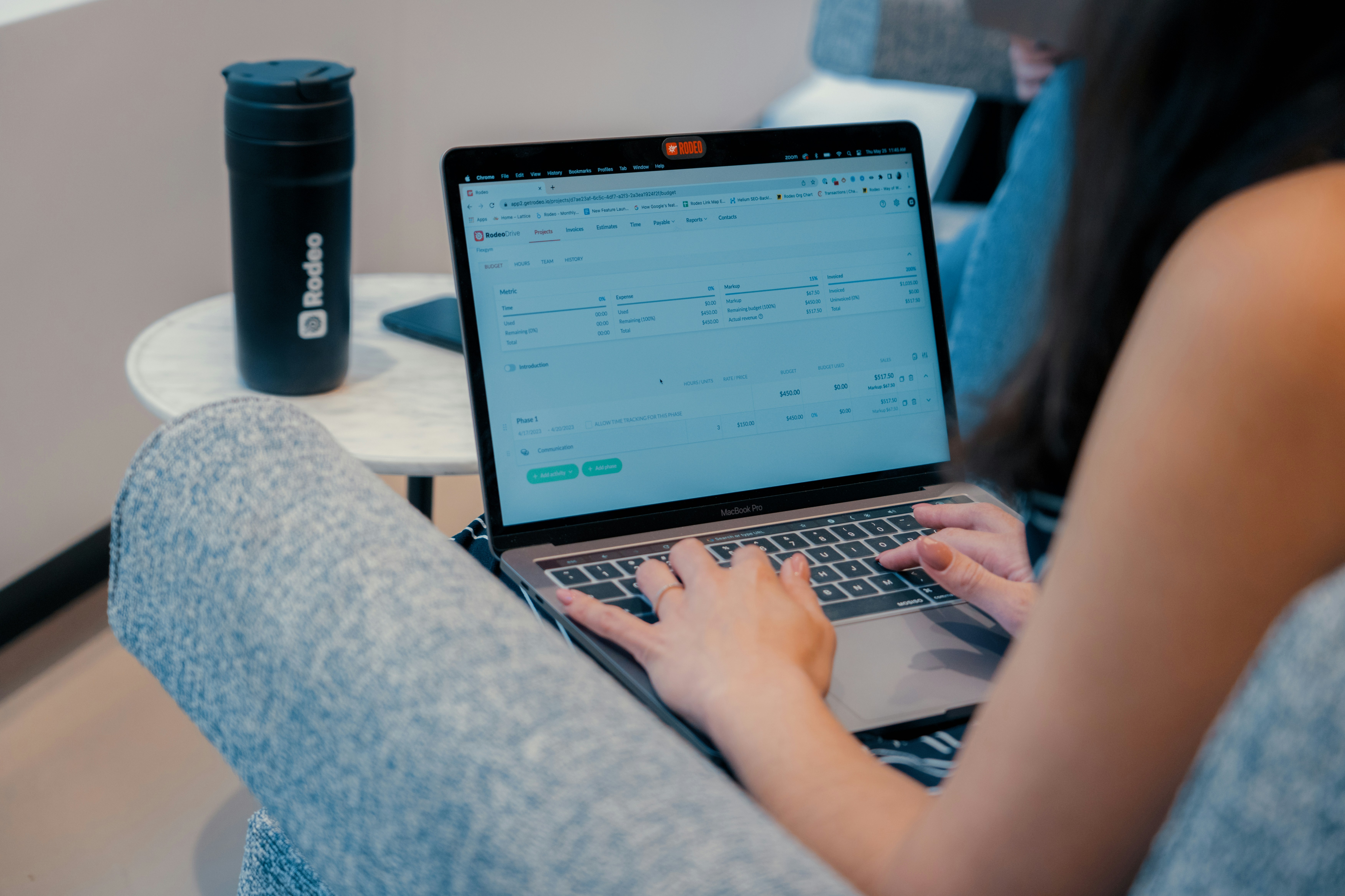 a woman sitting on a couch using a laptop computer