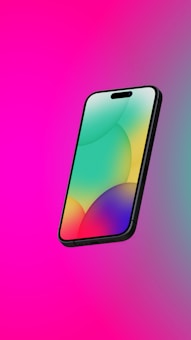 A sleek smartphone with a vibrant, colorful display featuring abstract circular patterns. The phone is set against a bright pink background, giving it a modern and dynamic appearance.