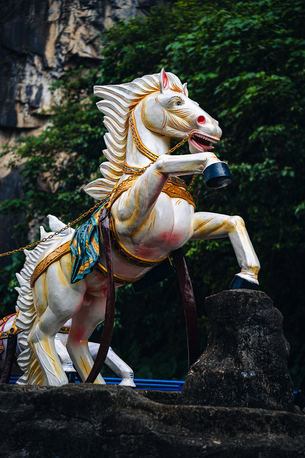 a statue of a horse with a bell on its back