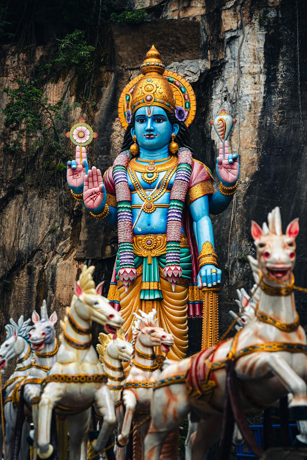 a statue of a hindu god surrounded by other statues