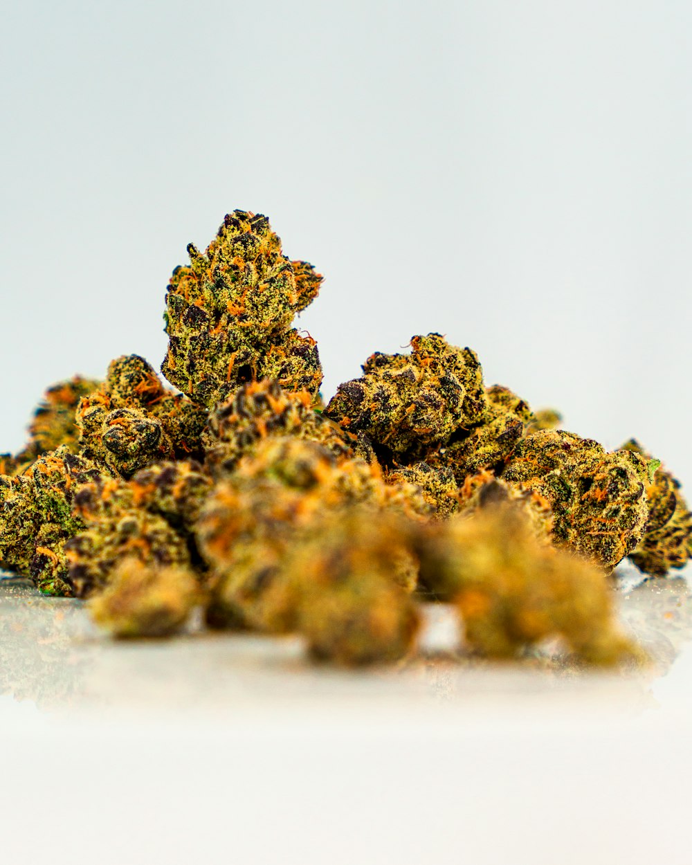 a pile of yellow weed sitting on top of a white table