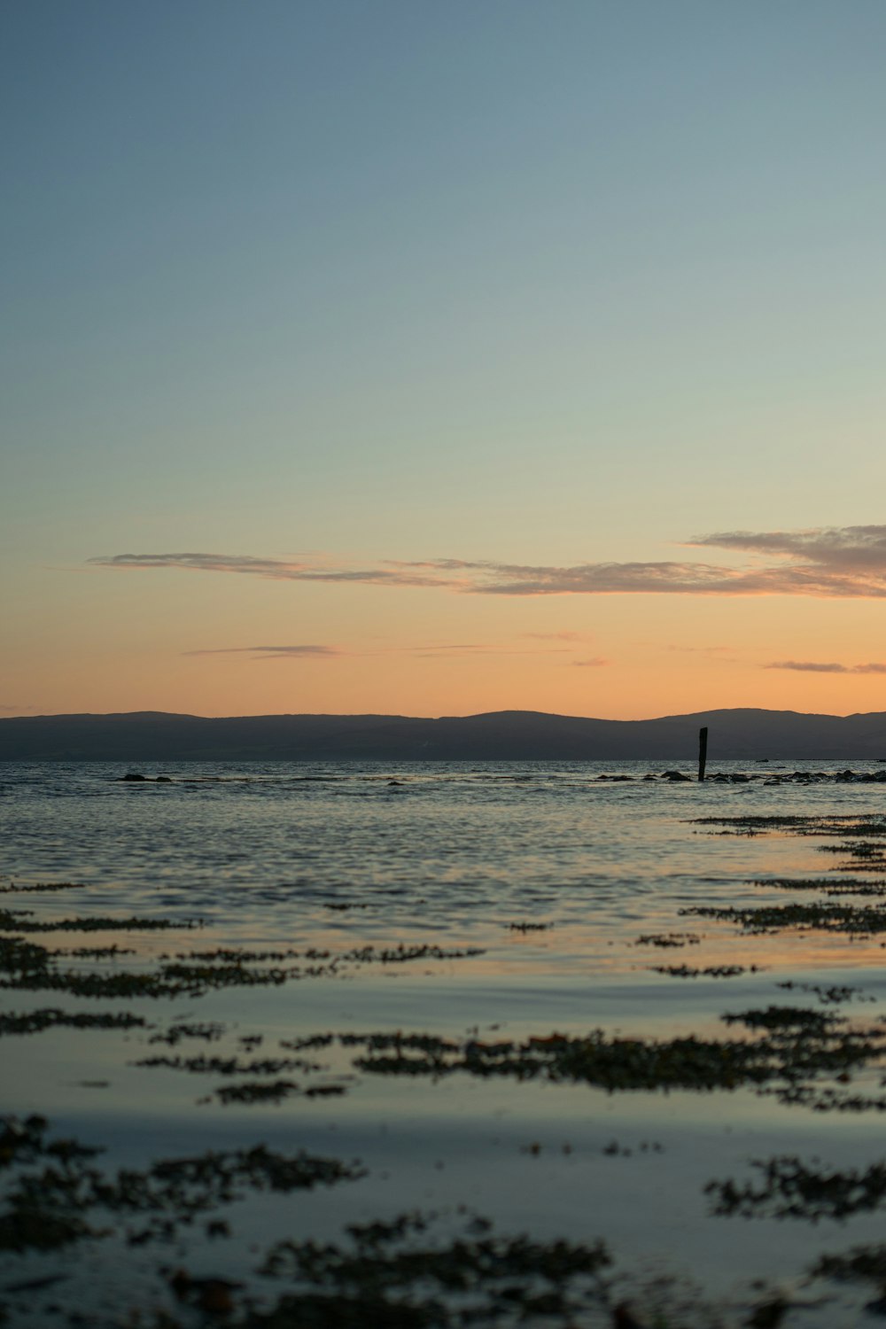 a body of water with a boat in the distance