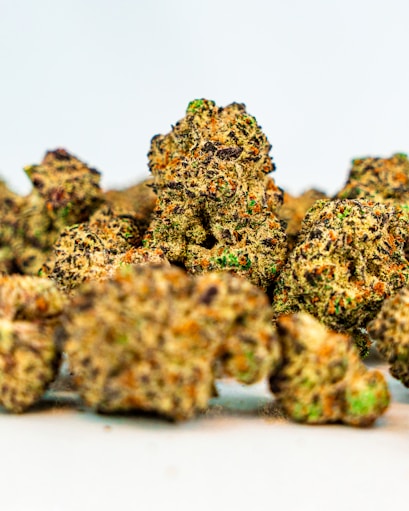 a pile of marijuana buds sitting on top of a white table