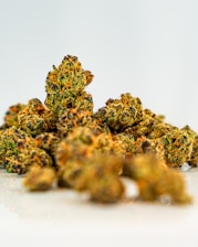 a pile of yellow weed sitting on top of a white table