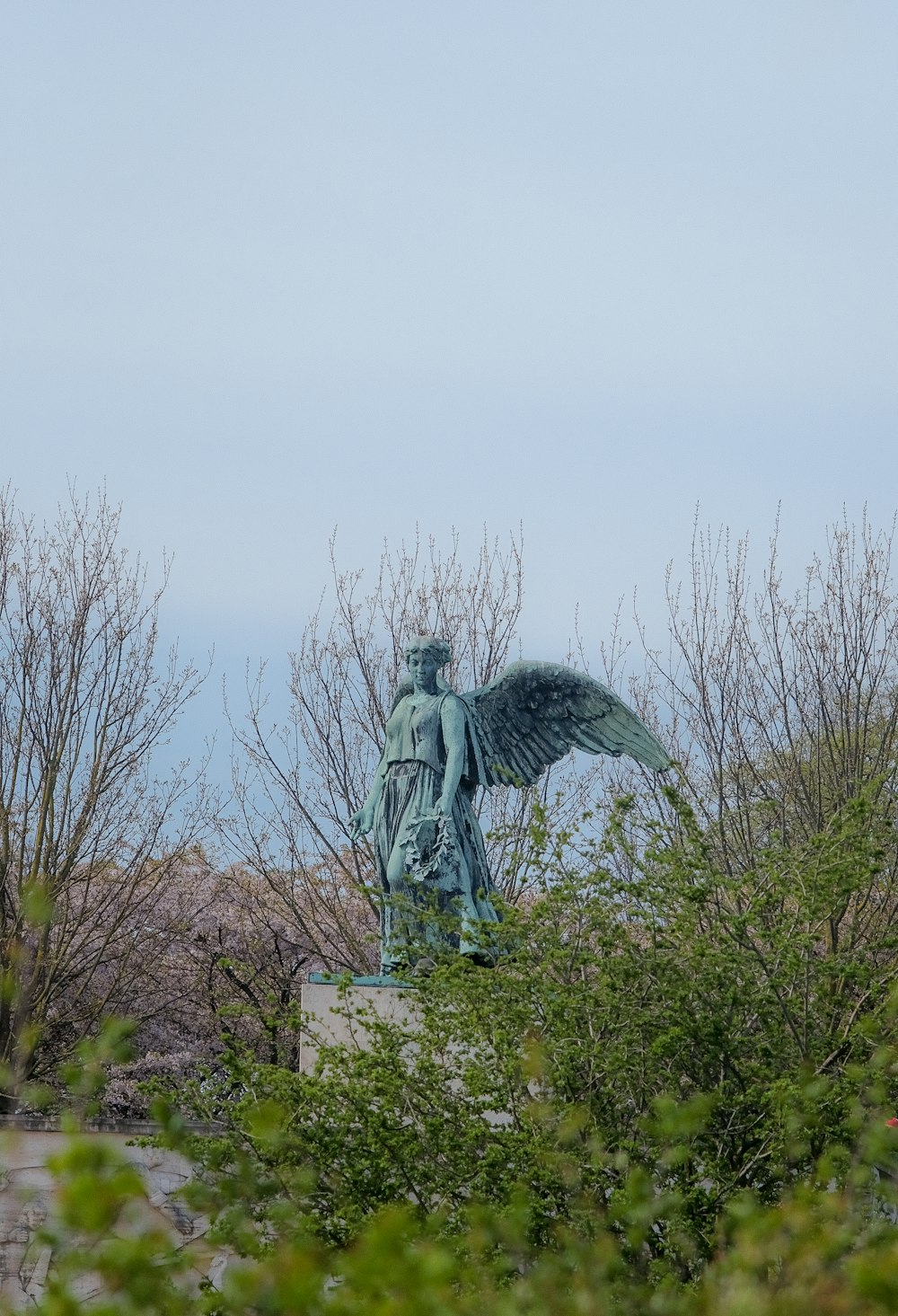 a statue of an angel on top of a hill