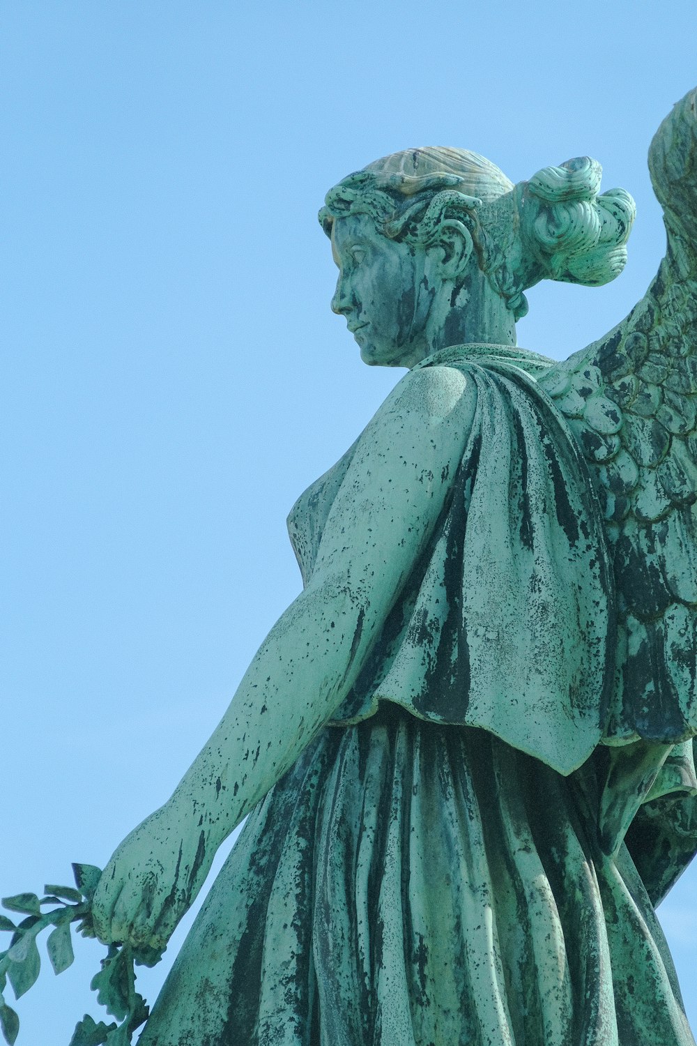 a statue of an angel holding a branch